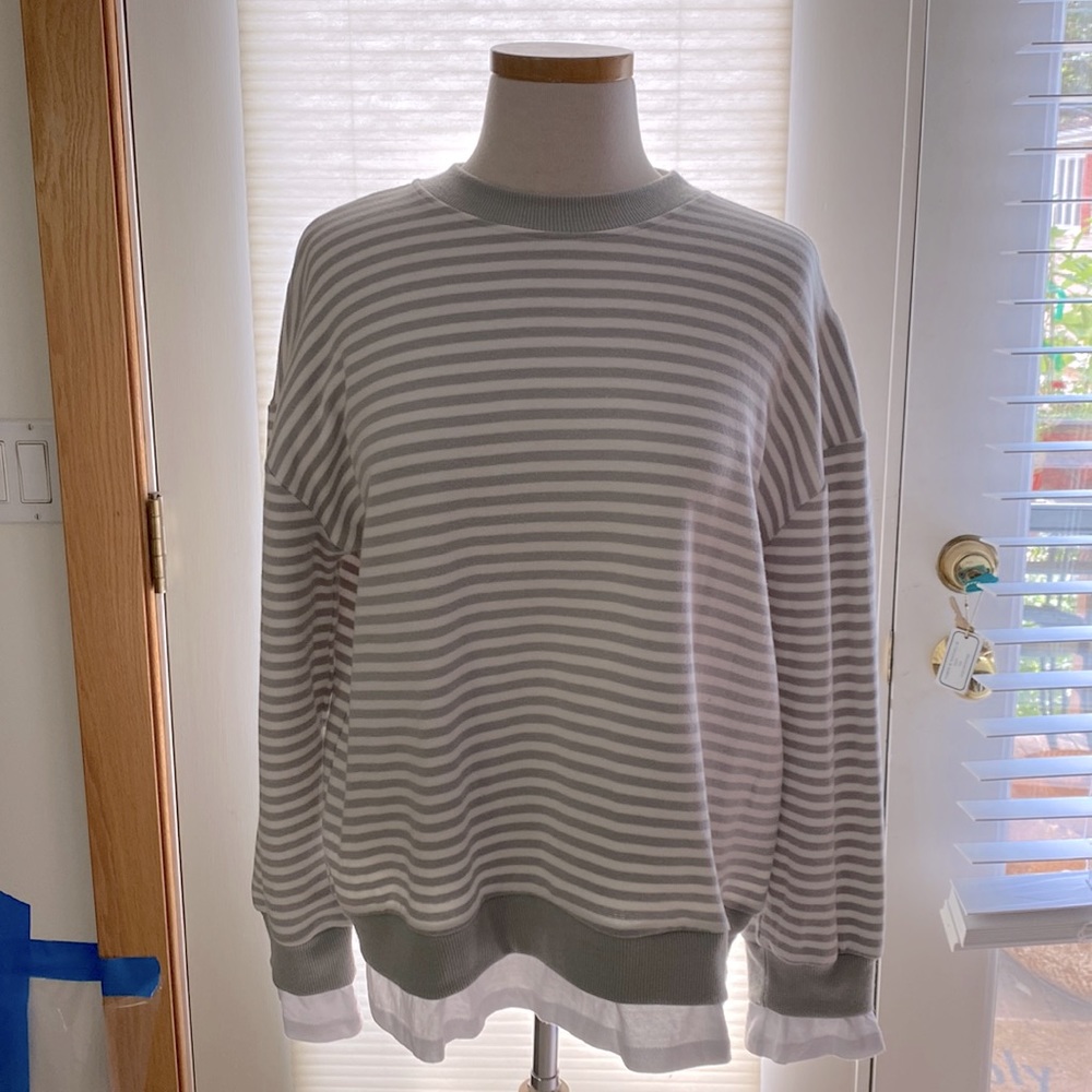 Striped cotton and 1 % spandex sweater top with shirt detail at sleeves and hem.